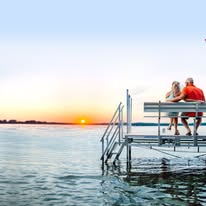 Couple relaxing at sunset on a dock